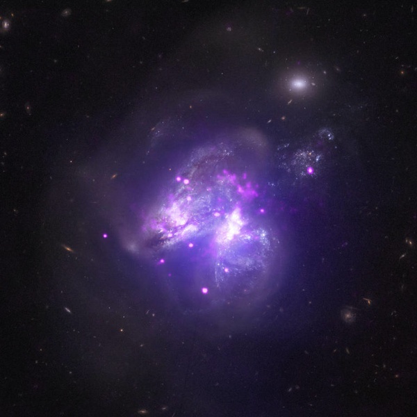 Galáxia Arp 299: sistema em que duas galáxias estão se fundindo, com estrelas de cada galáxia se misturando entre si.
